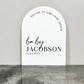 White Arch Acrylic Baby Shower signs that reads "WELCOME TO JAMIE'S BABY SHOWER baby JACOBSON 05.20.2023"